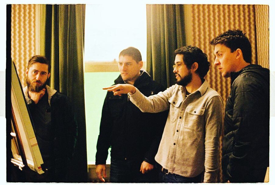 Carlos and three other people in front of a window.