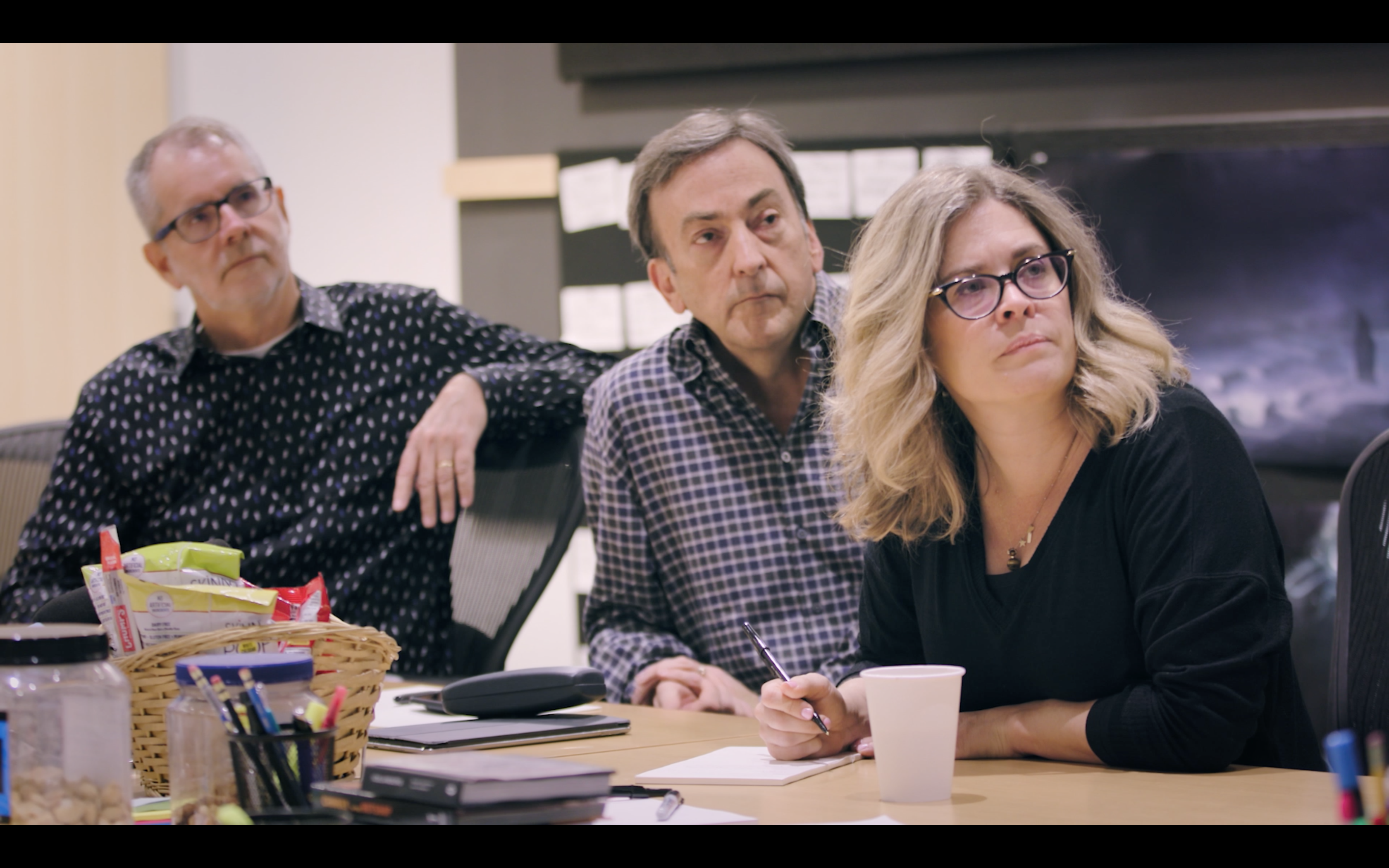 Jen and two men at a meeting table.