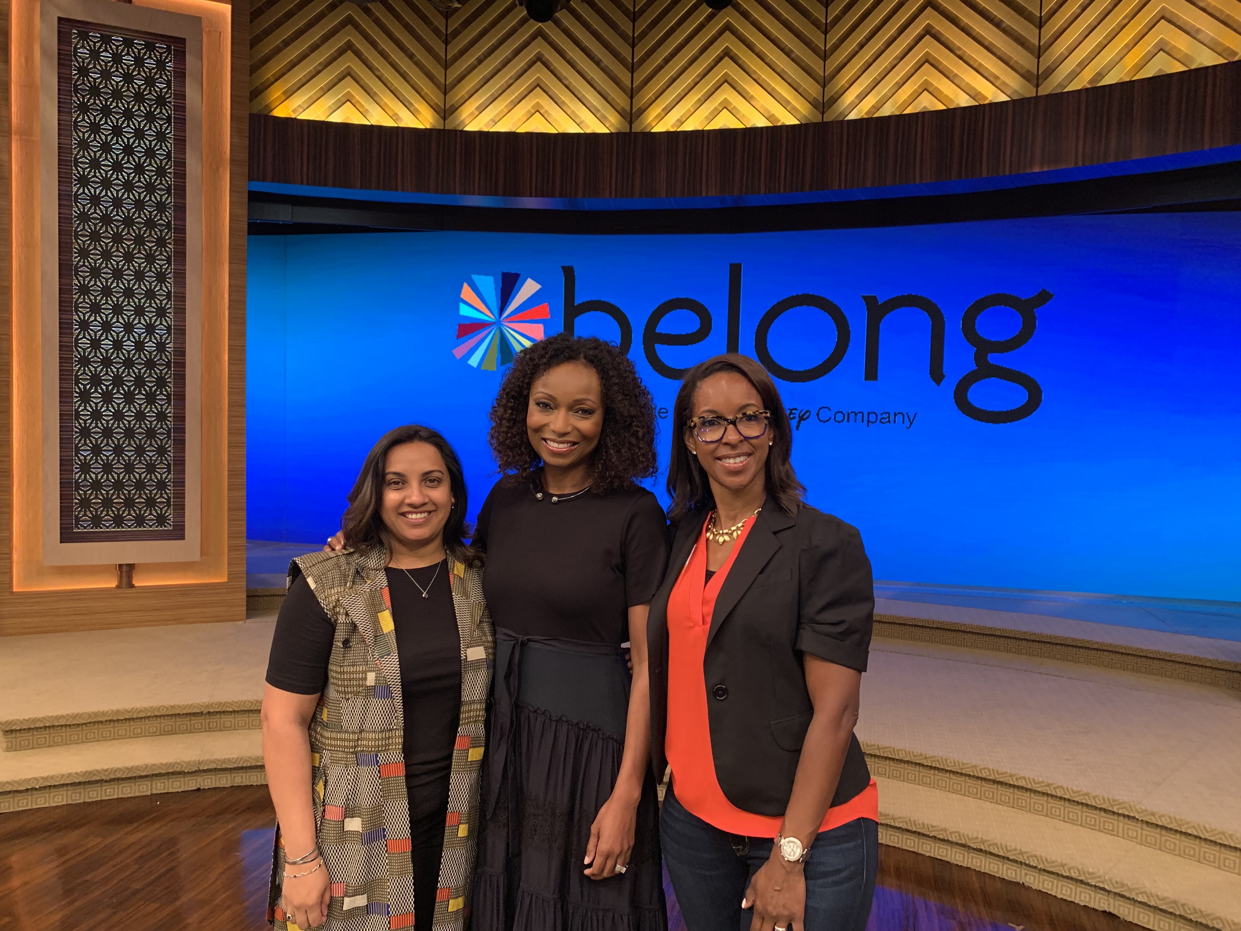 Leslie and two other women smiling at the camera.