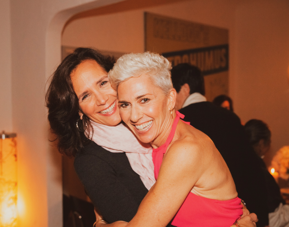 Linda and her wife smiling at the camera.