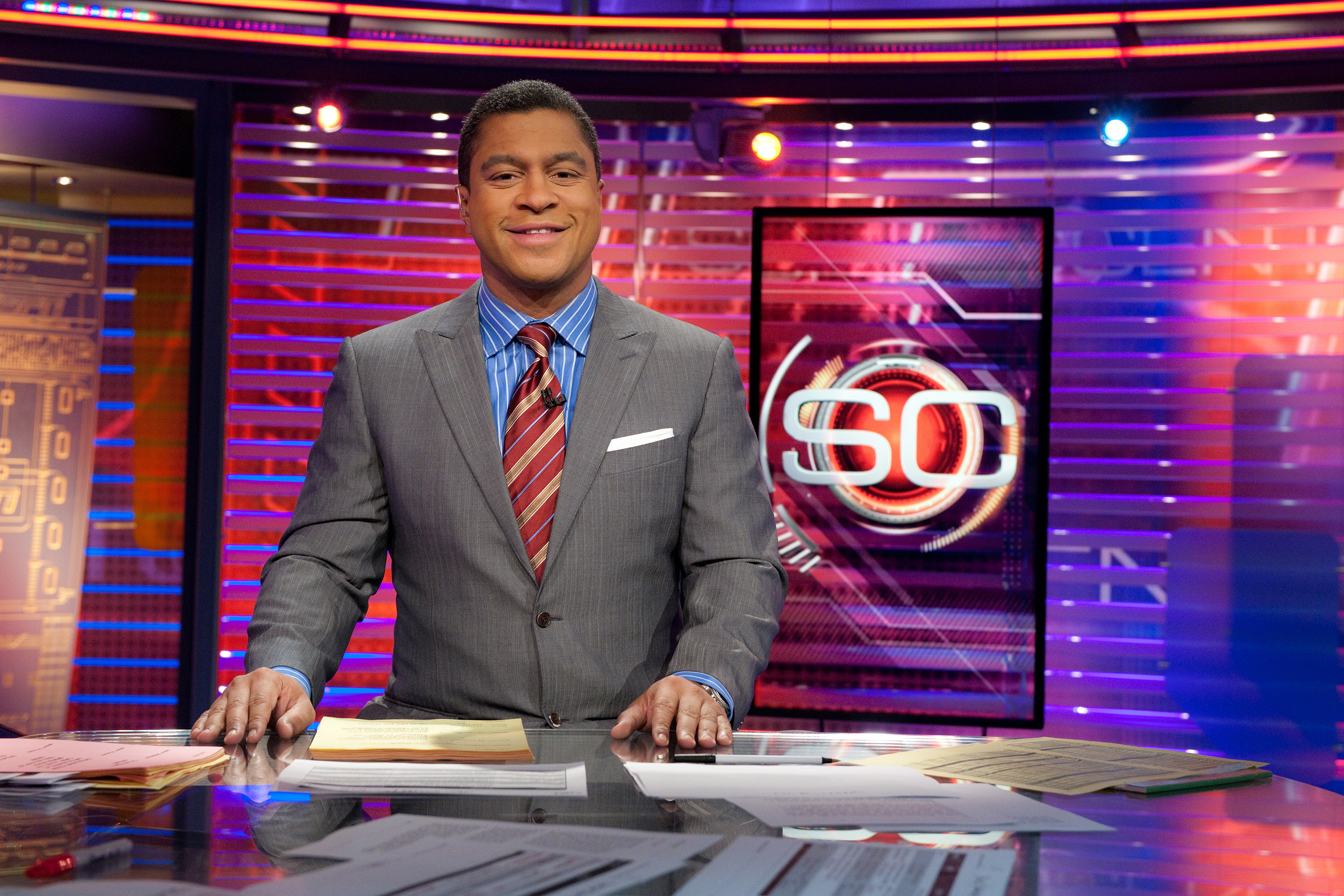Stan on the set of Sportscenter smiling at the camera.