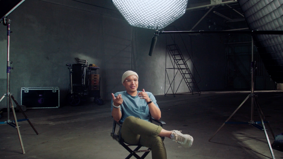 Jeremy sitting in a director's chair on set.