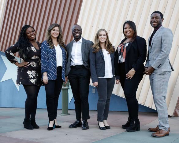 Six people smiling at the camera.