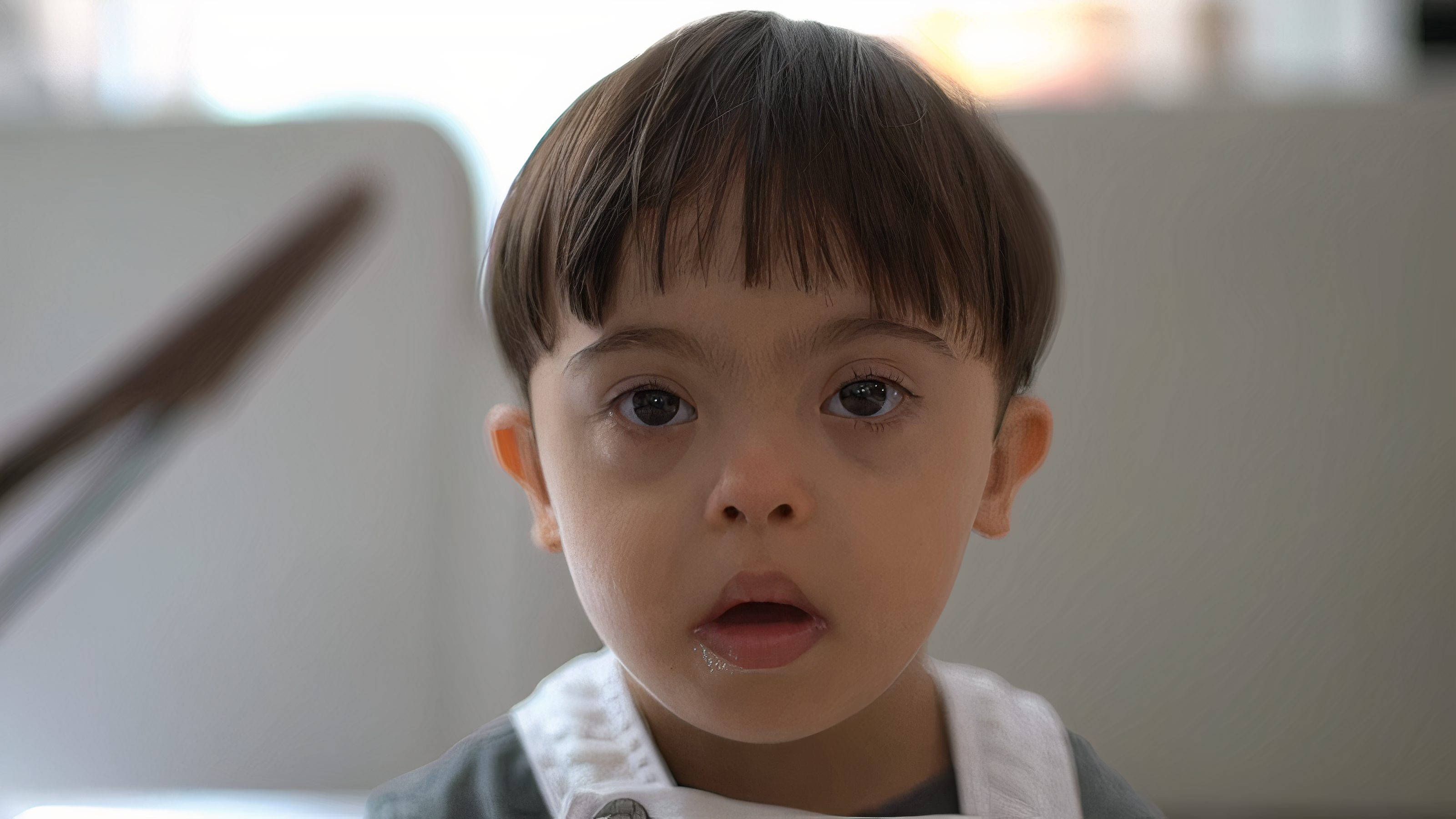 A little boy looking at the camera.